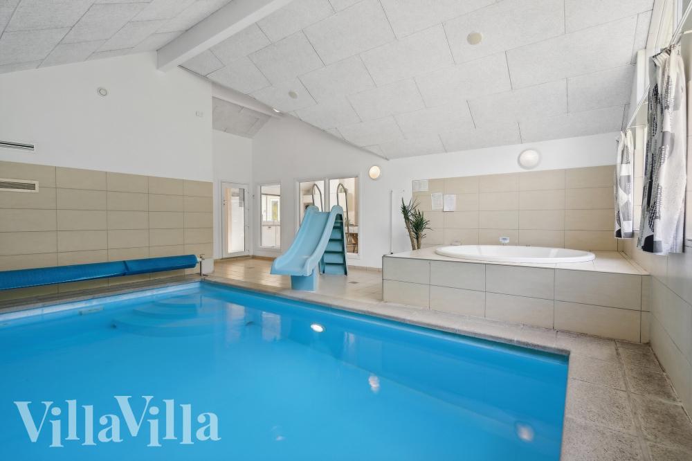 Das Ferienhaus 320 hat einen schicken Poolbereich mit Wasserrutsche, einem geräumigen, eingelassenen Whirlpool und einer Sauna.