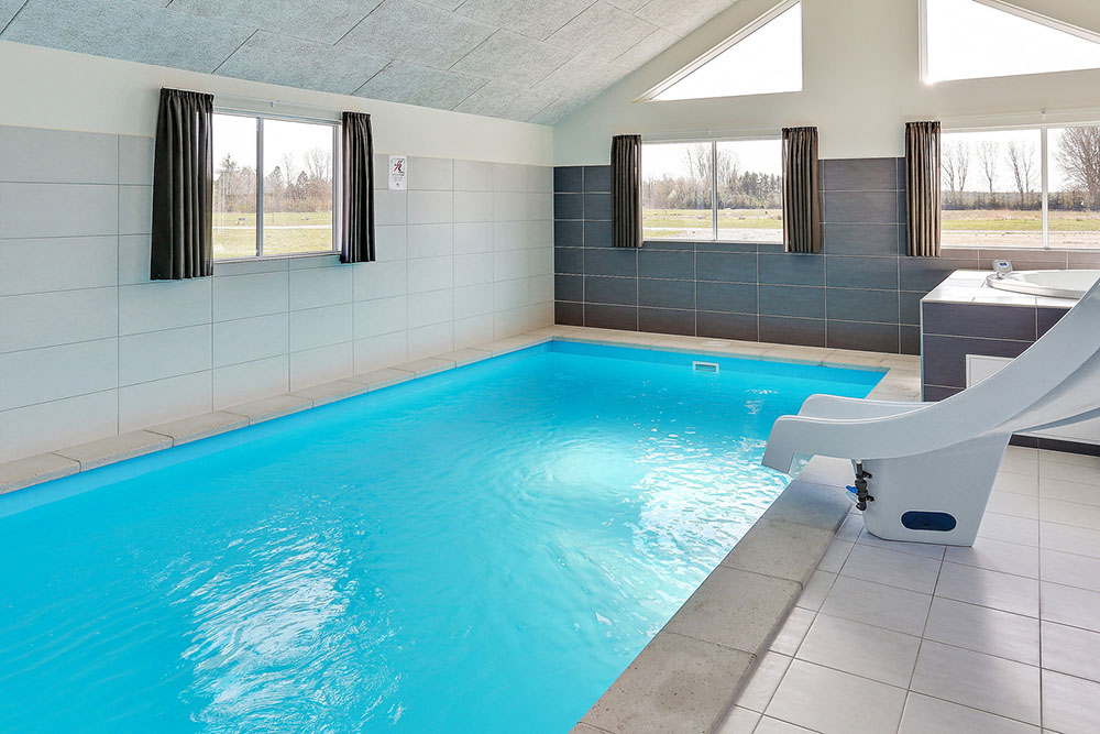 Das Ferienhaus 343 hat einen schicken Poolbereich mit Wasserrutsche, einem geräumigen, eingelassenen Whirlpool und einer Sauna.