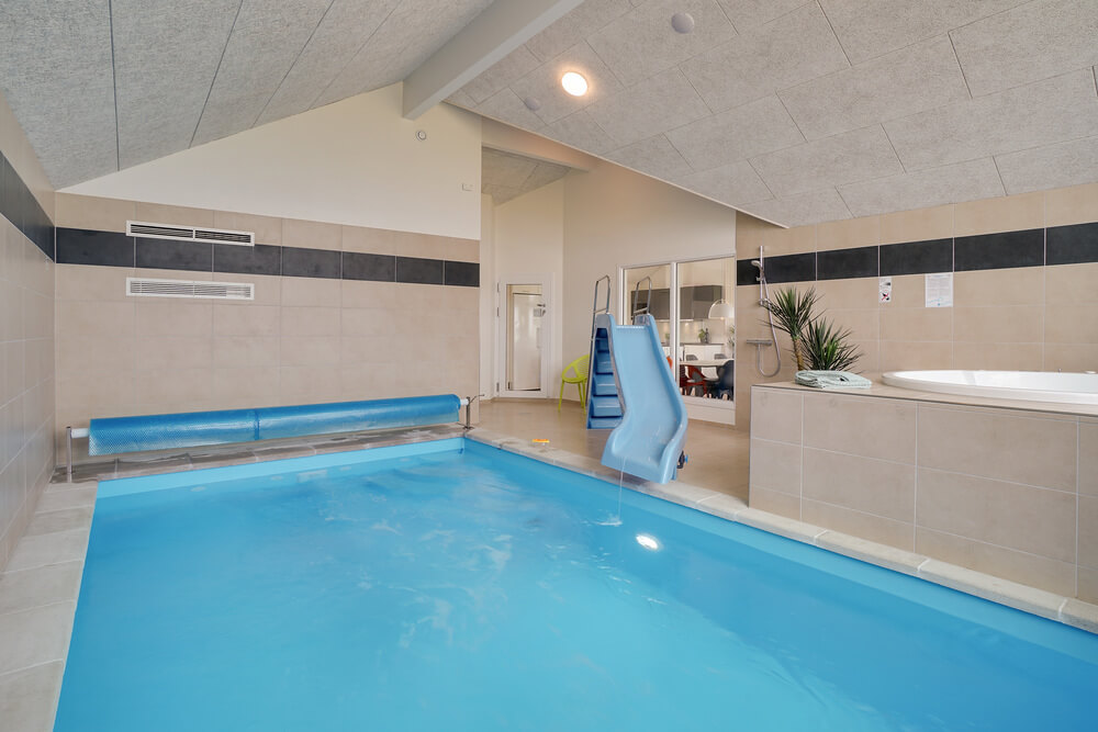 Das Ferienhaus 437 hat einen schicken Poolbereich mit Wasserrutsche, einem geräumigen, eingelassenen Whirlpool und einer Sauna.