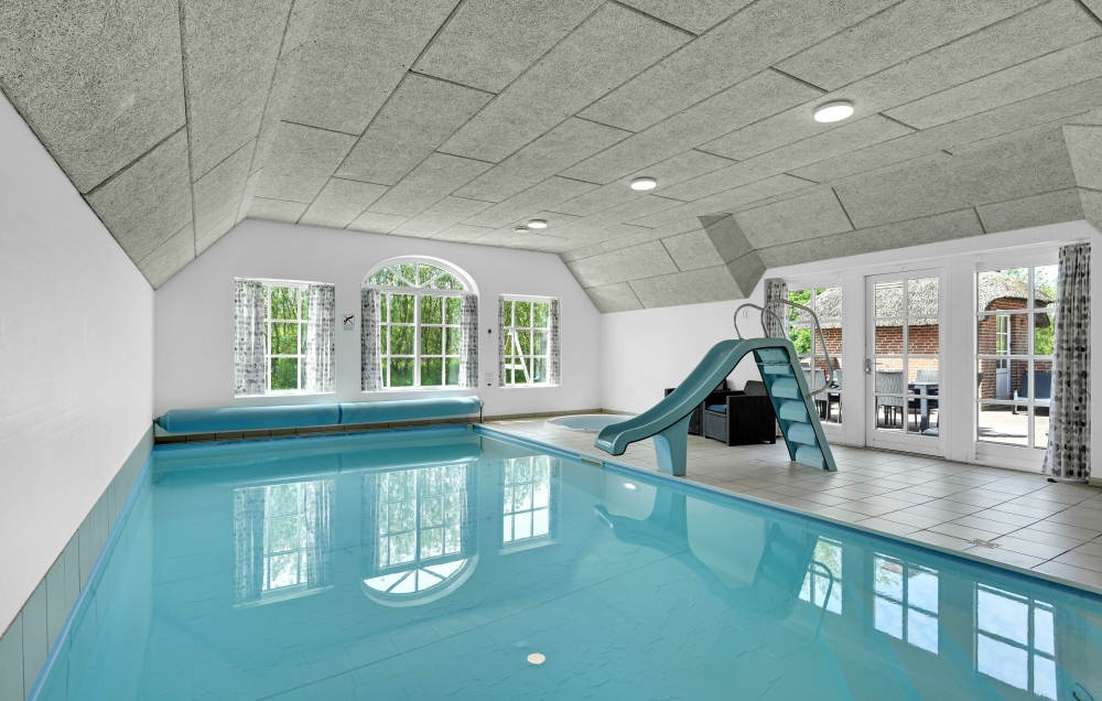 Das Ferienhaus 575 hat einen schicken Poolbereich mit Wasserrutsche, einem geräumigen, eingelassenen Whirlpool und einer Sauna.