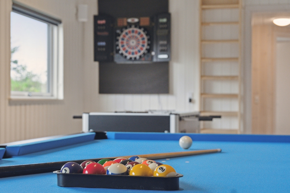 Neben den vielen schönen Stunden, die man im Poolbereich des Hauses verbringen kann, bietet das Luxusferienhaus 634 auch Spielevergnügen bei Billard/Tischtennis und Darts